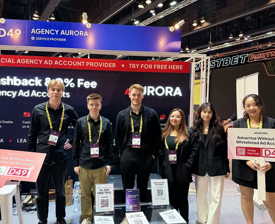 Six members of the Aurora team standing together at the Aurora stand